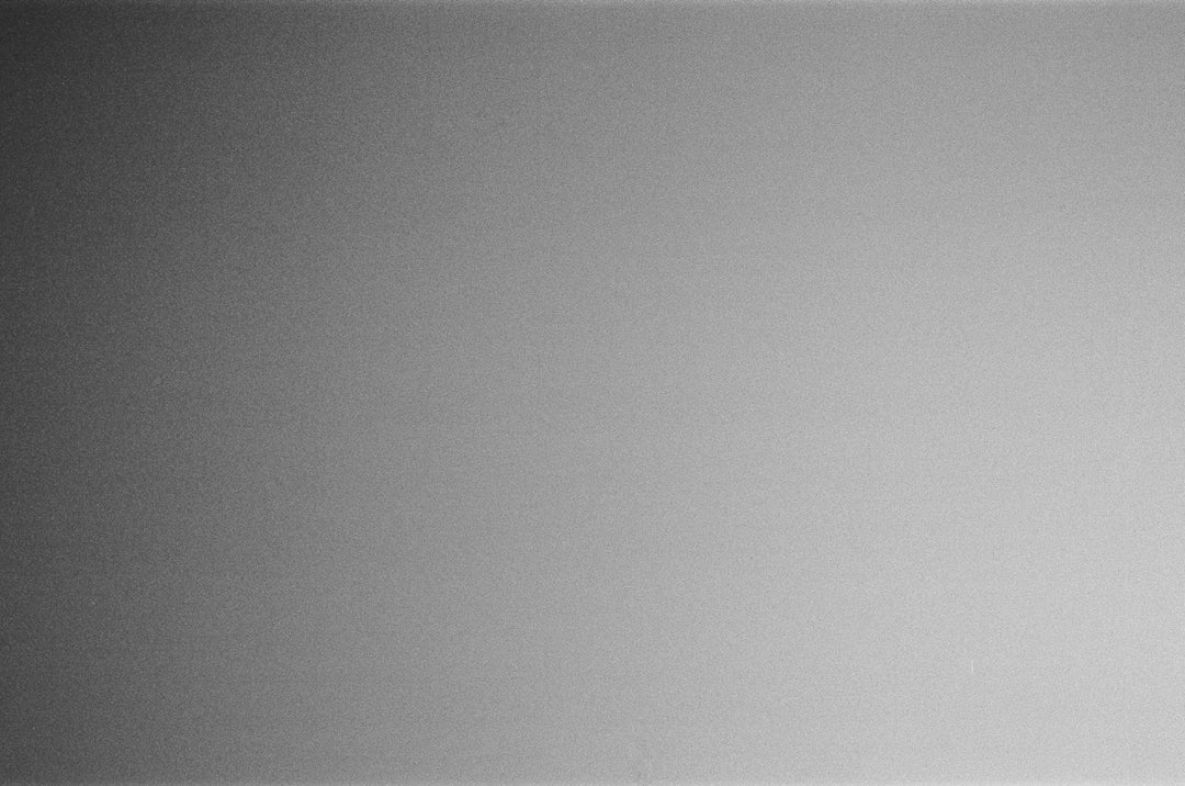 a black and white photo of a person holding a cell phone