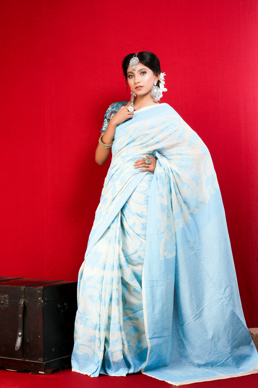 woman in white and blue floral dress