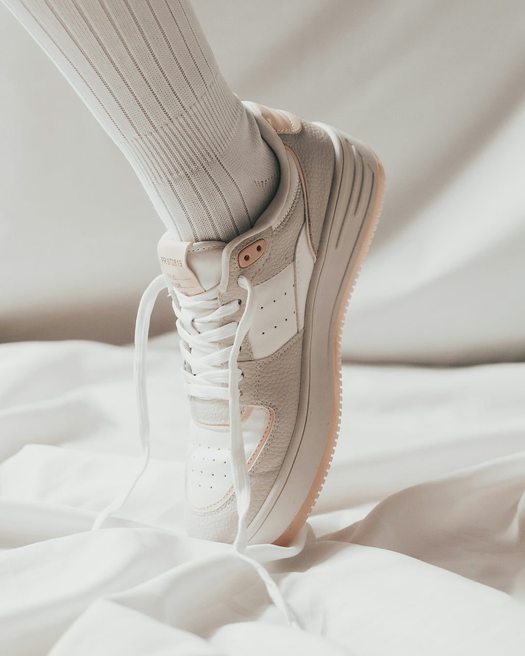 person wearing white nike air force 1 low