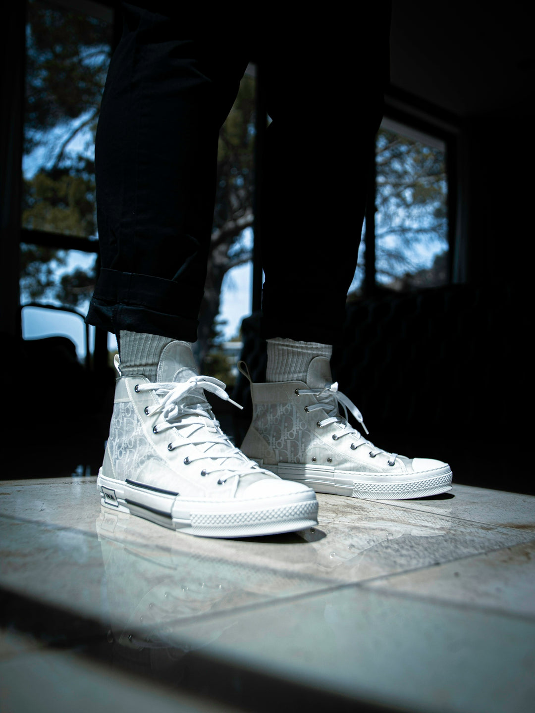 person in blue denim jeans and white nike sneakers
