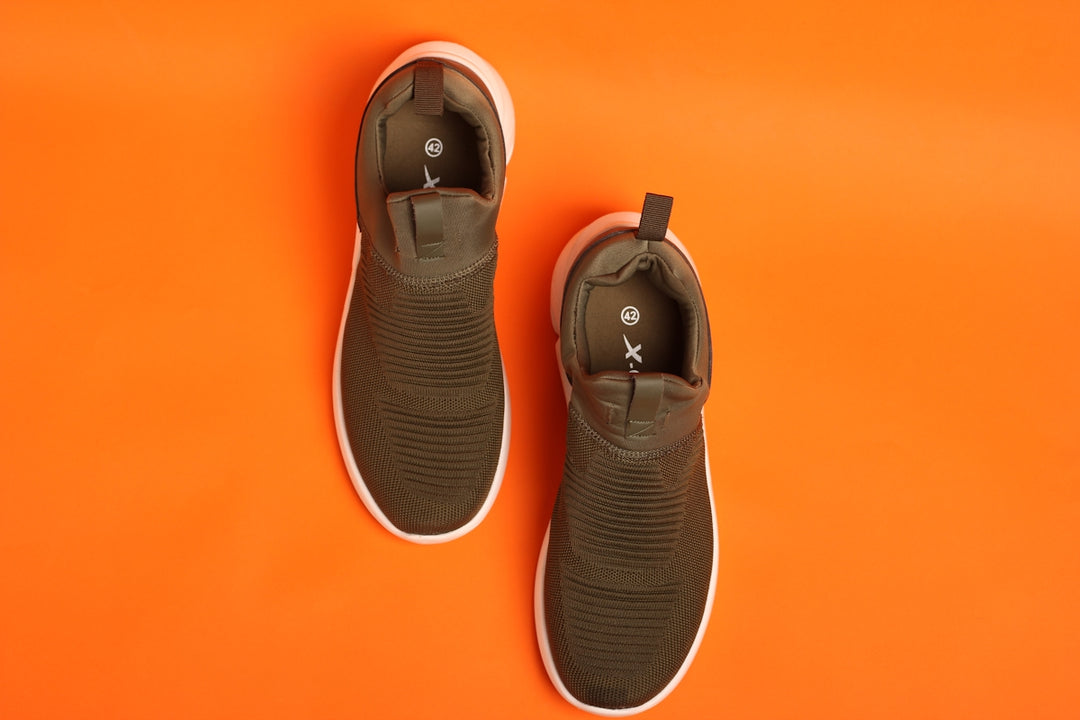 a pair of shoes on an orange background