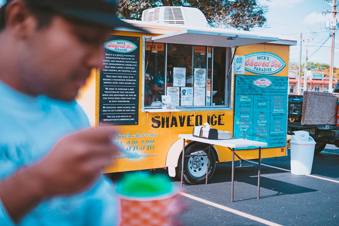a man standing in front of a food truck