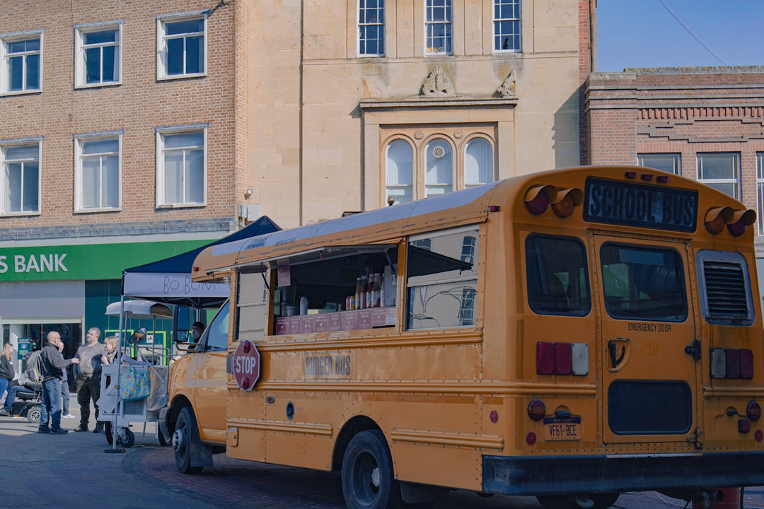 a yellow bus parked on the side of a street