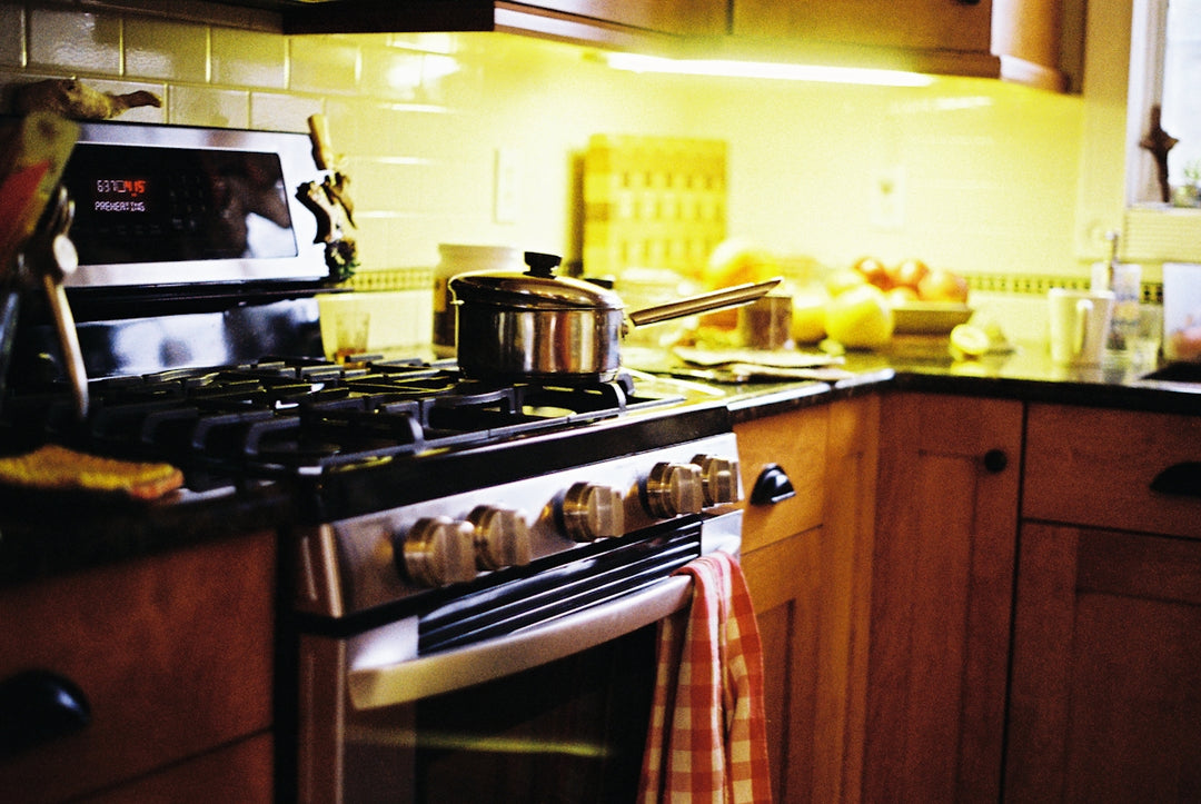 a stove top oven sitting inside of a kitchen