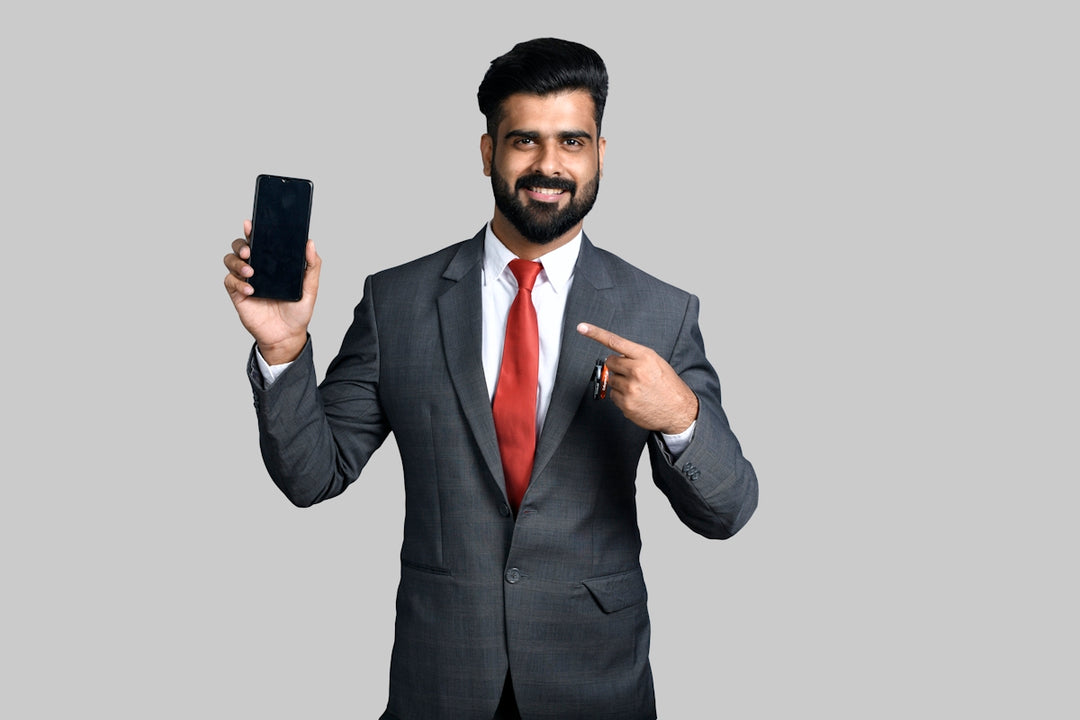 a man in a suit holding a phone up to his ear