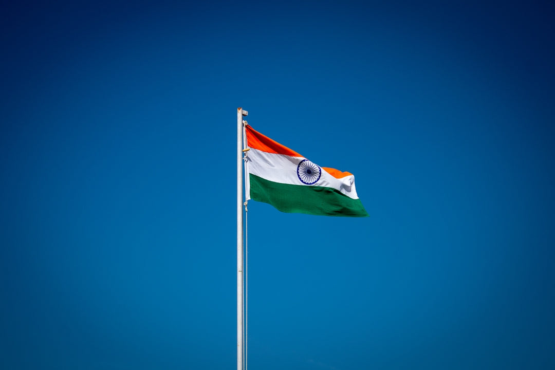 the indian flag is flying high in the blue sky