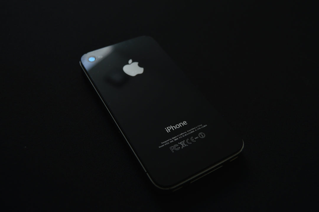 a close up of an iphone on a black surface