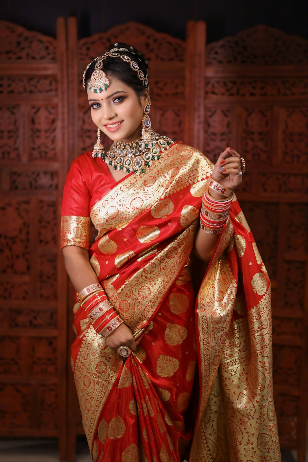a woman in a red and gold sari