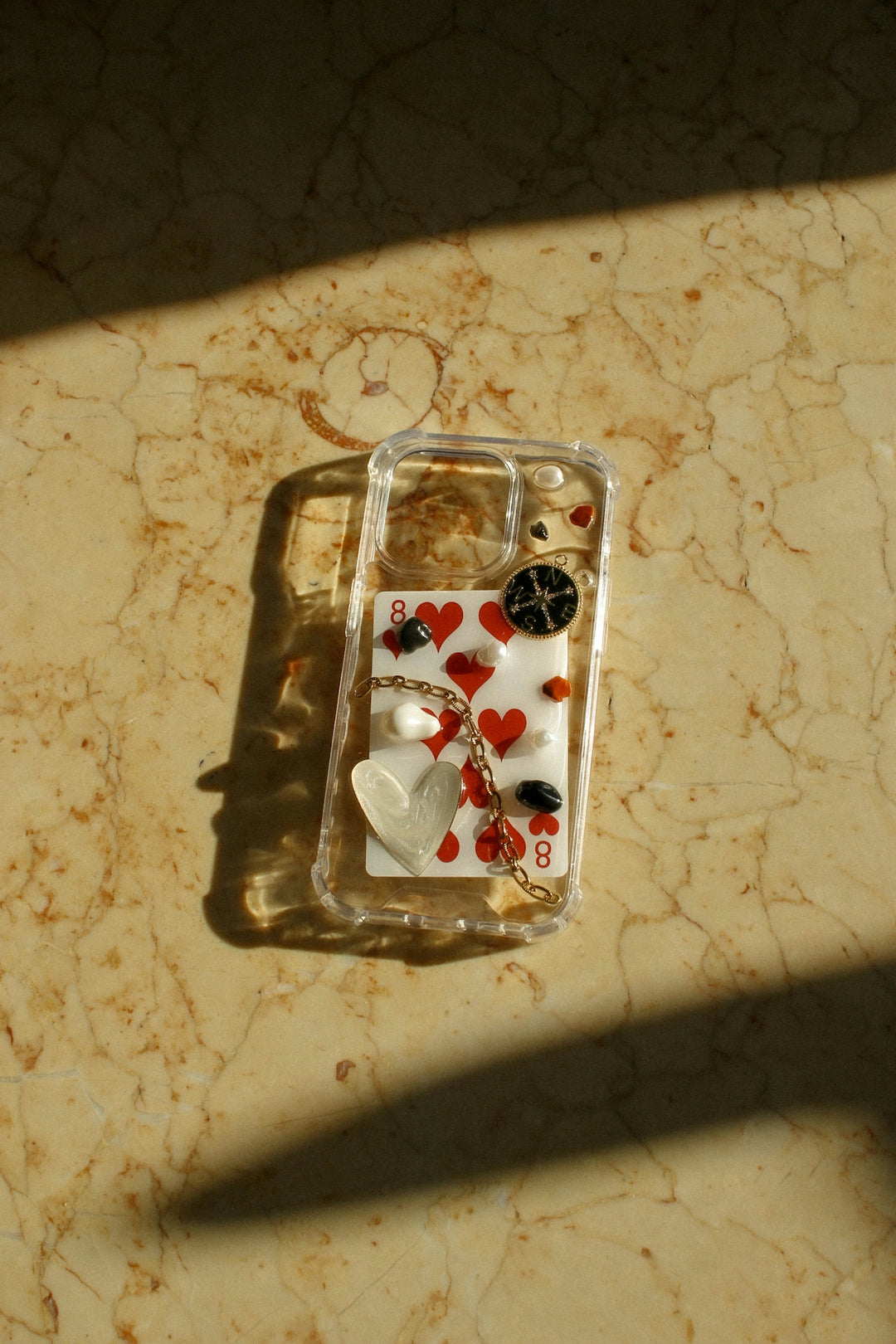 A cell phone case with hearts and buttons on it