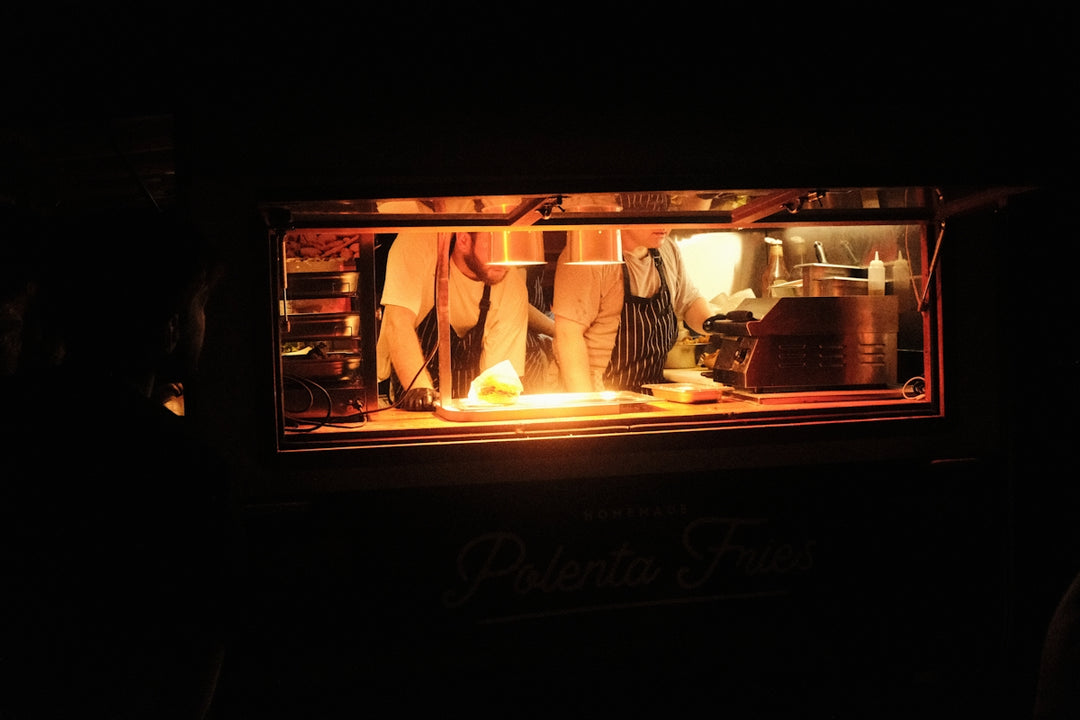 A person standing in front of a fire in a stove
