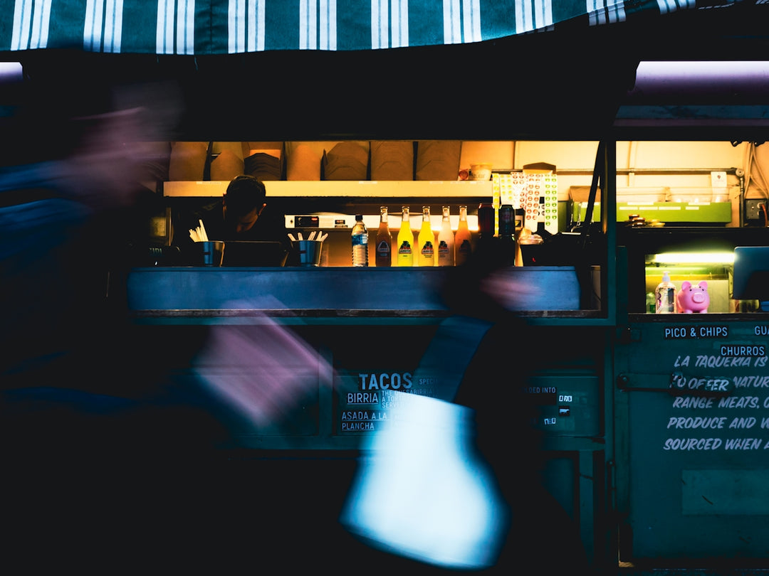 A blurry photo of people walking past a restaurant