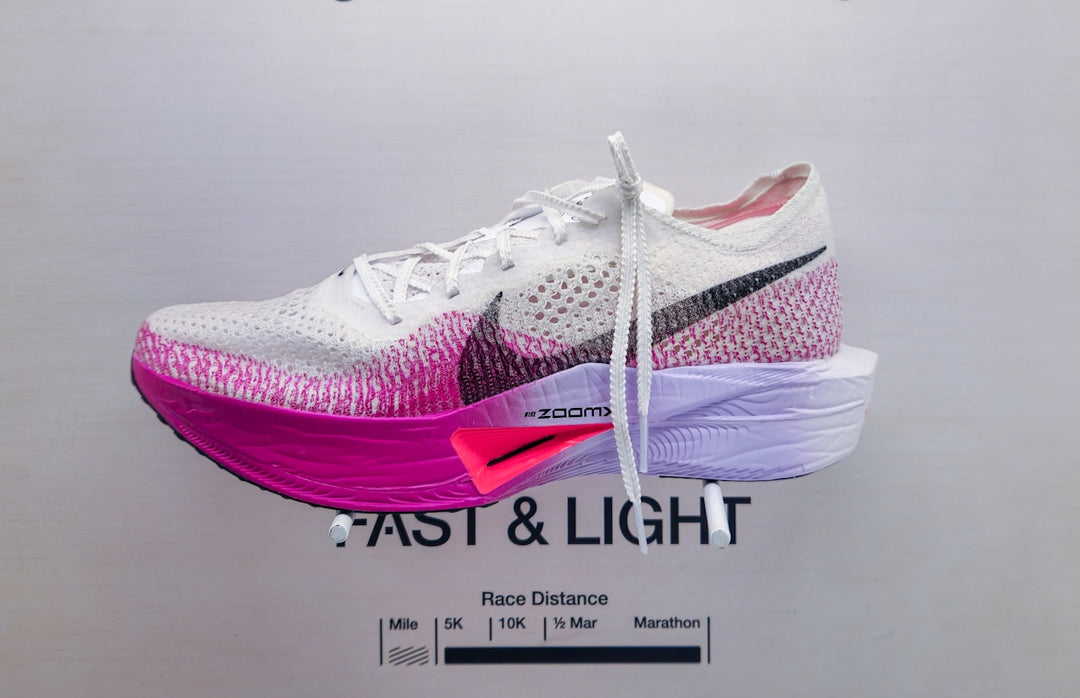 A pair of nike shoes on display on a wall