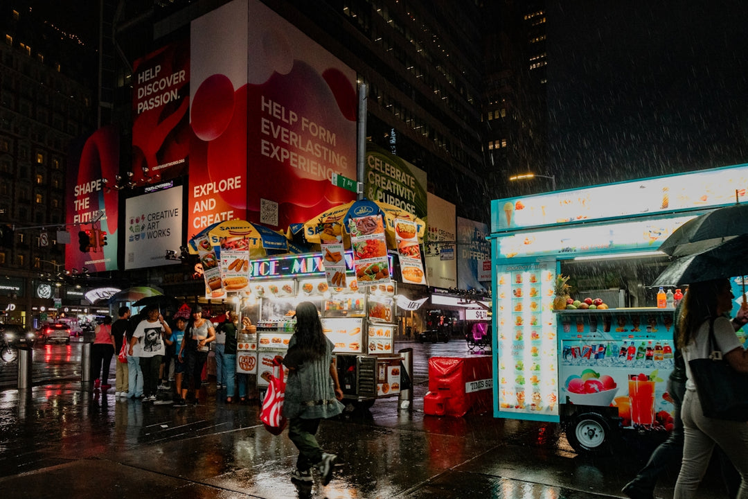 A group of people walking down a street at night