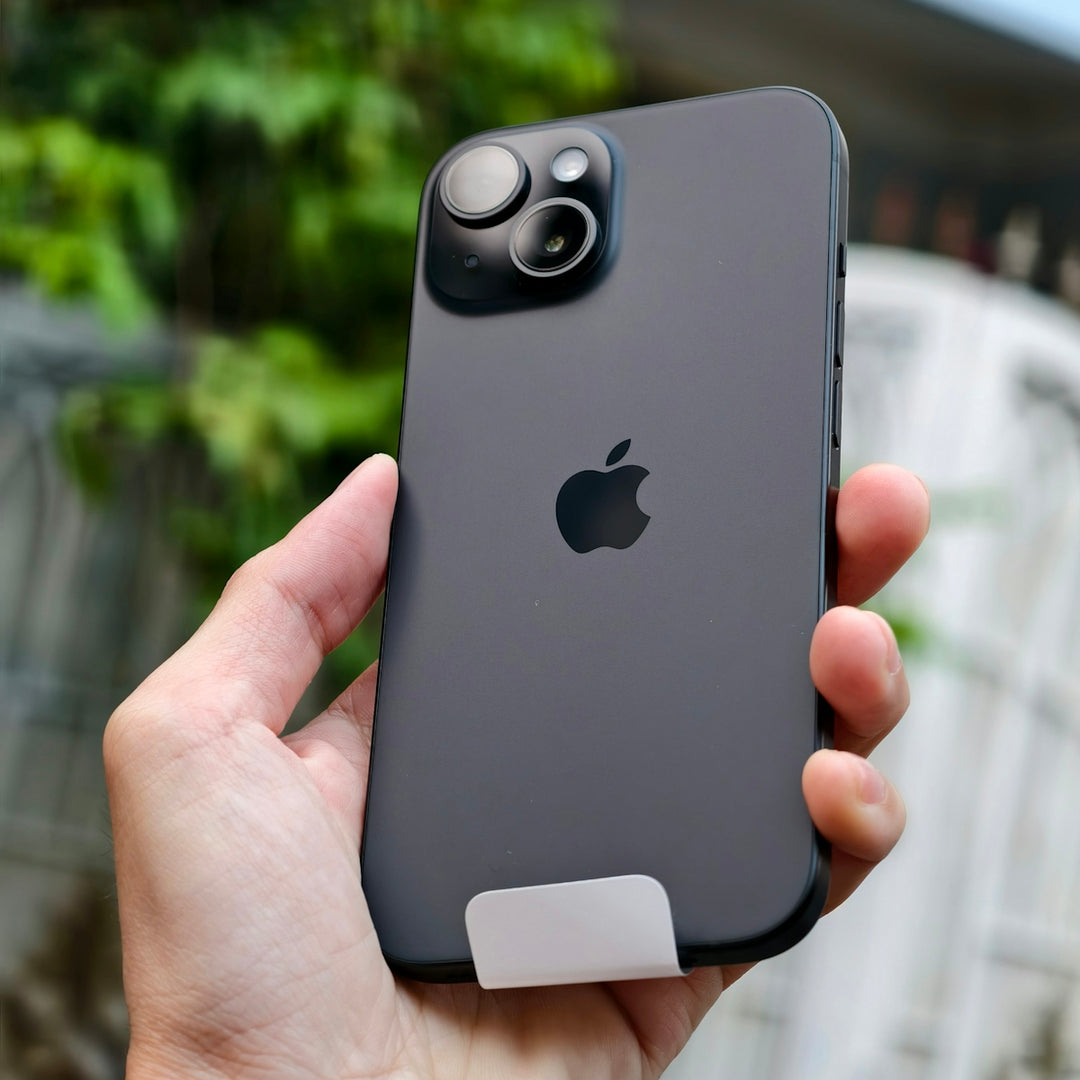 A person holding an iPhone in their hand