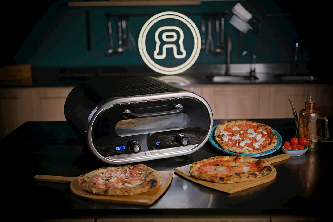 A couple of pizzas sitting on top of a counter