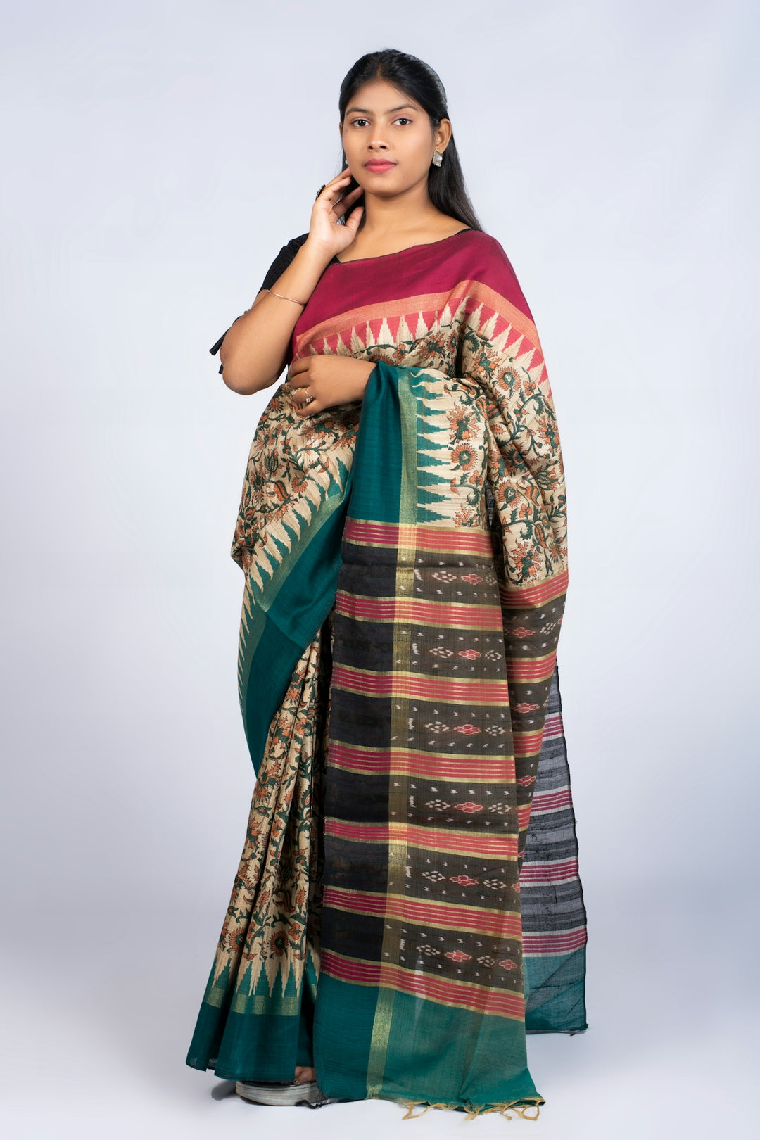 Woman poses in a beautiful, patterned saree.