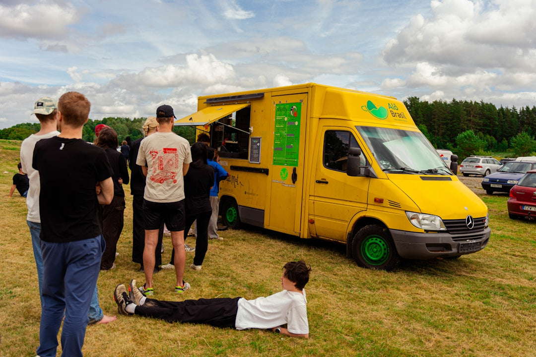 People are lining up at a food truck.