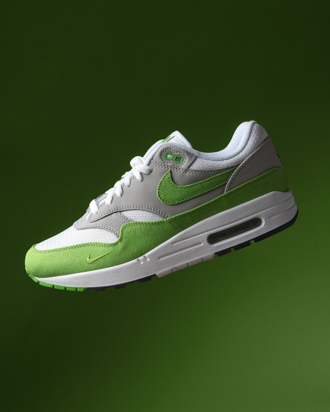 A nike air max 1 sneaker floats gracefully.