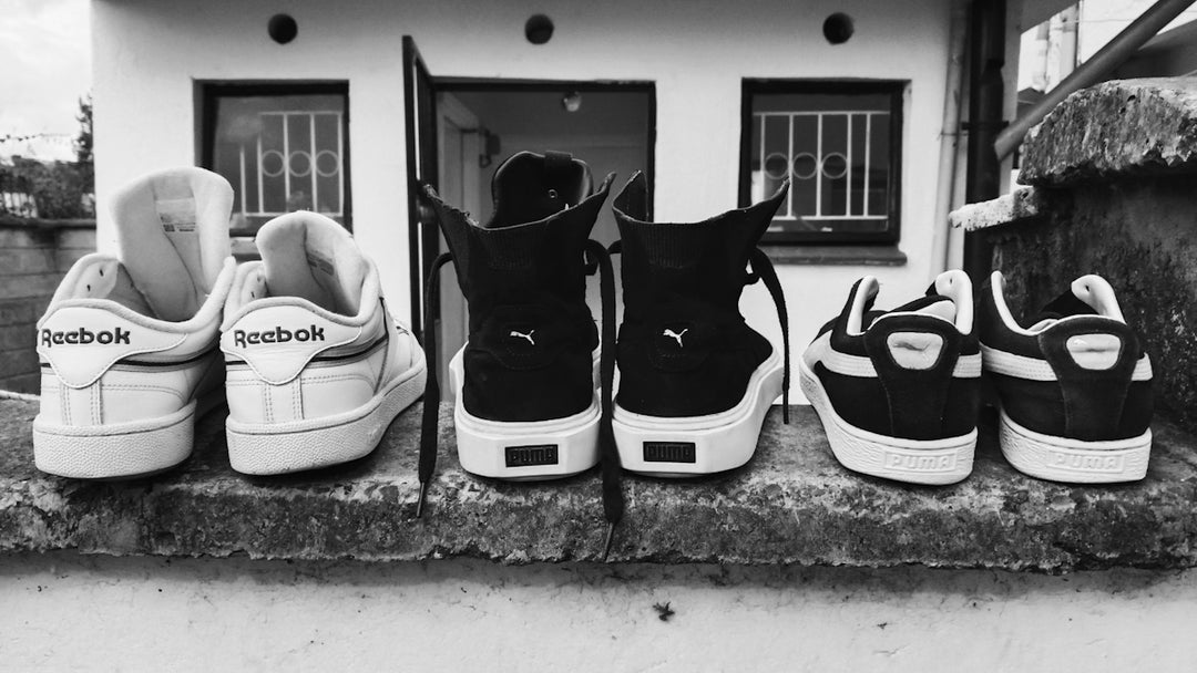 Shoes are lined up on a wall.