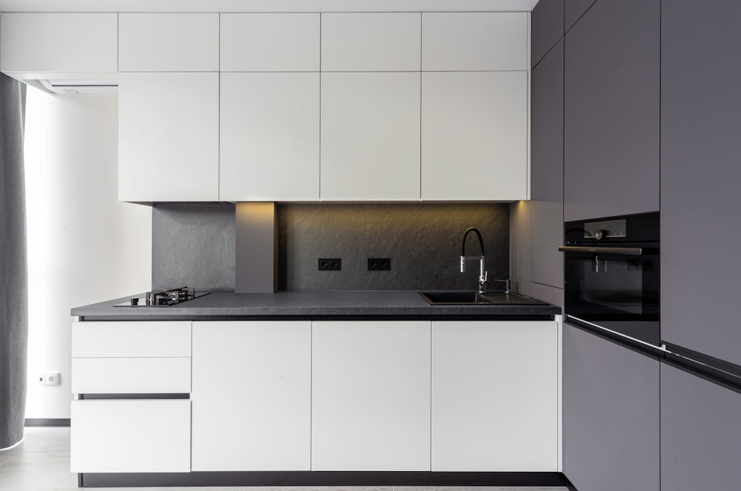 A modern kitchen features sleek white and gray cabinets.