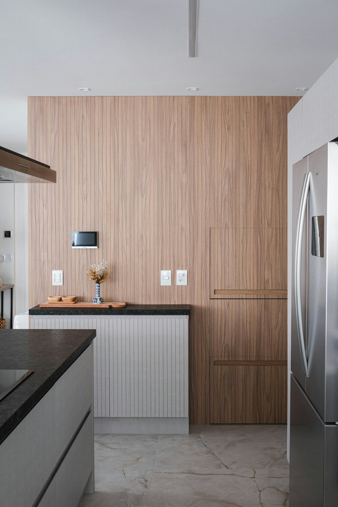 A modern kitchen showcases wood paneling and stainless steel.
