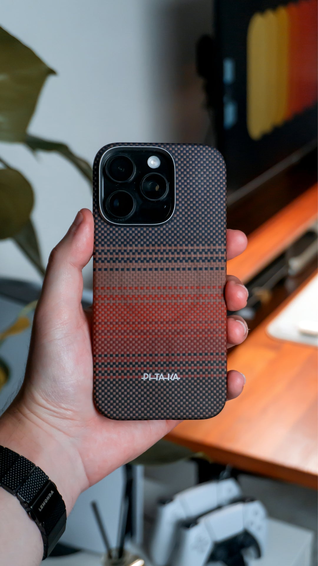A hand is holding an iPhone with a case.