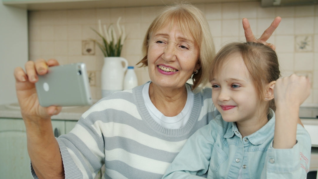 Grandmother and granddaughter taking a selfie together.