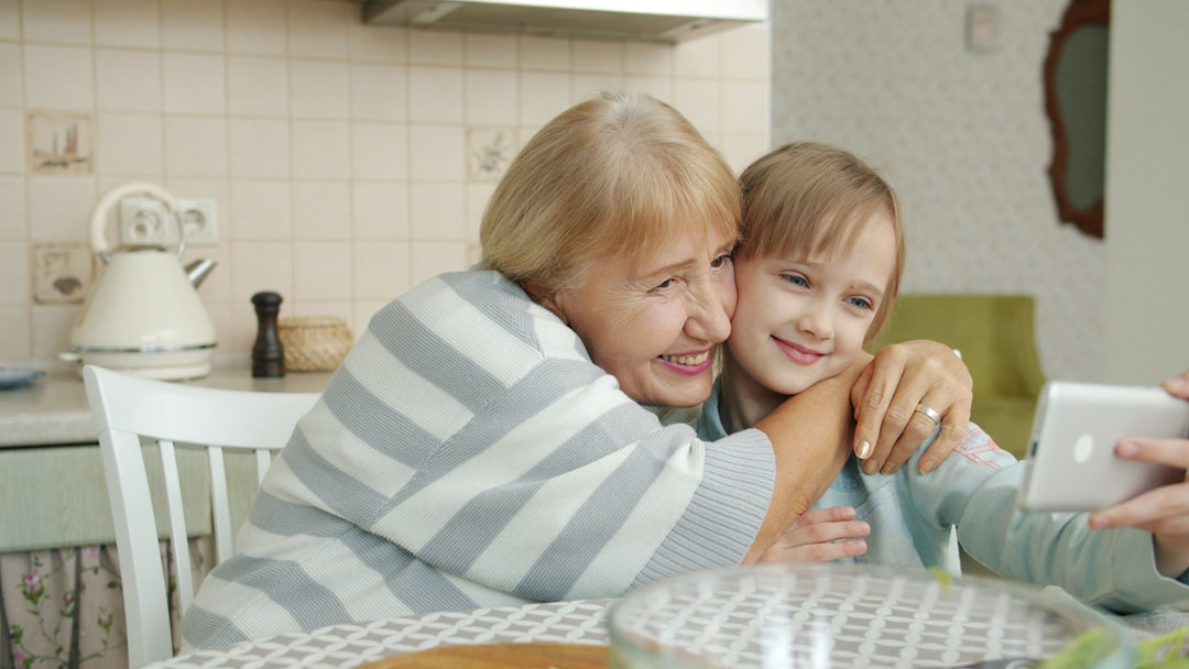 Grandmother and granddaughter taking a selfie together.