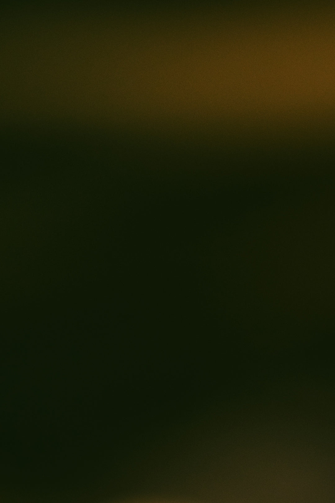 Dark abstract background with subtle warm light.