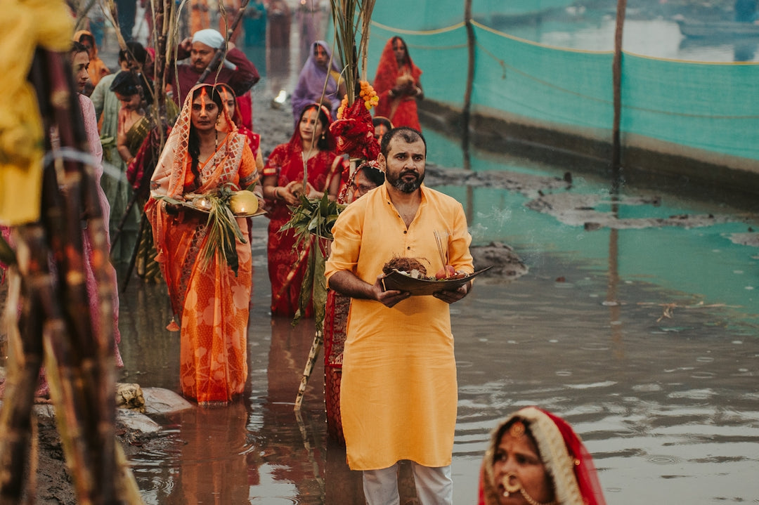 People in traditional indian attire by a river