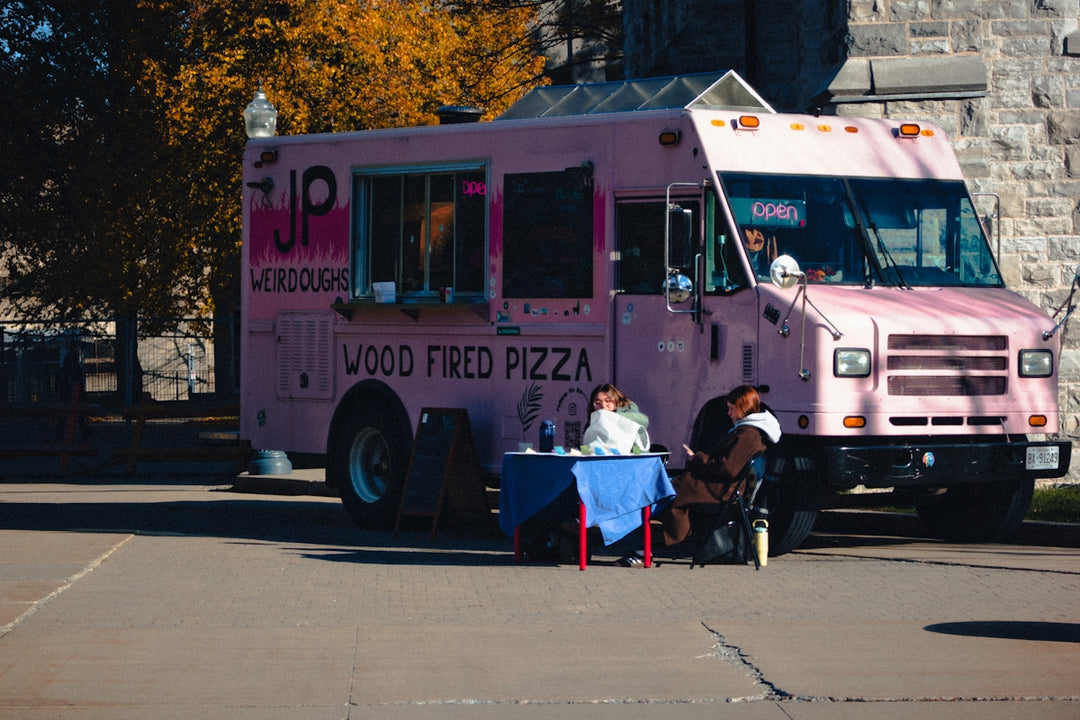 Pink food truck serving wood fired pizza