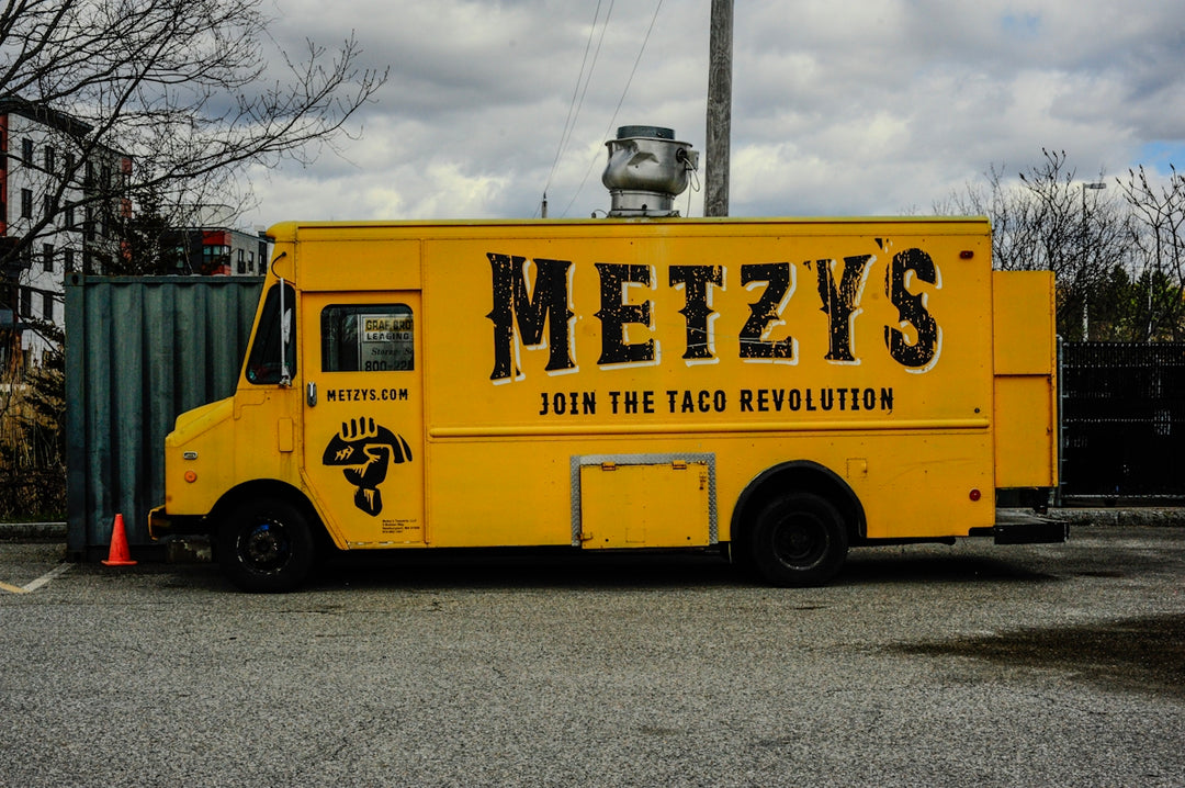 Yellow food truck with metzys and join the taco revolution