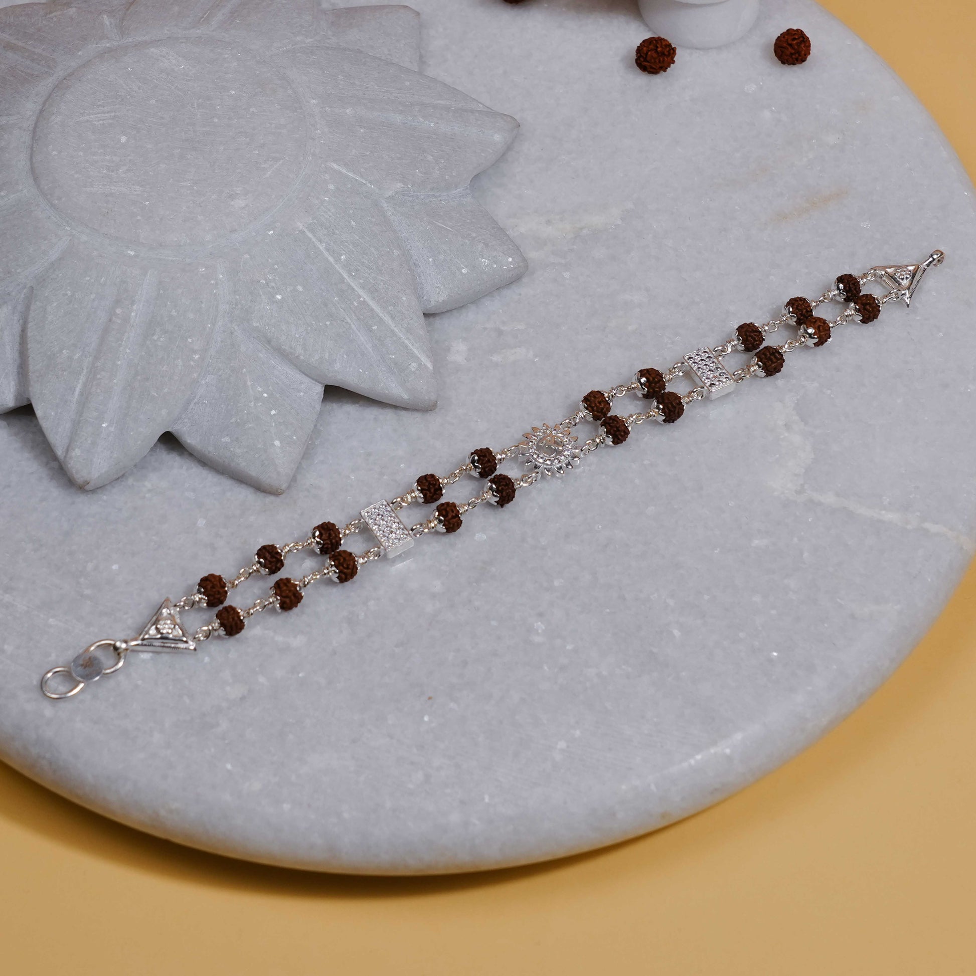 Silver Rakhi with Rudraksha, Om Flower Brooch, Double Line Bracelet