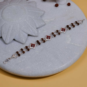 Silver Rakhi with Rudraksha, Om, and Three Rhombus Brooches, Double Line Design