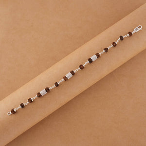 Silver Rakhi with Rudraksha and Three Diamond Cylinders