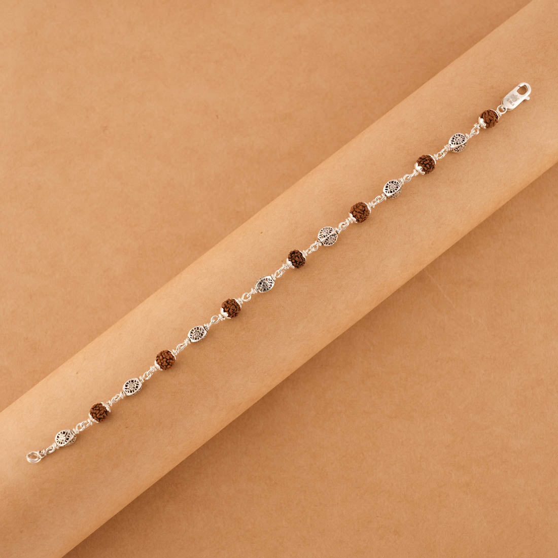 Silver Rakhi with Rudraksha and Hollow Circular Beads