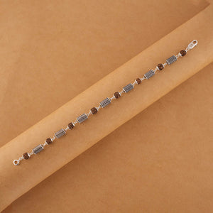 Silver Rakhi with Rudraksha and Hollow Cylindrical Beads