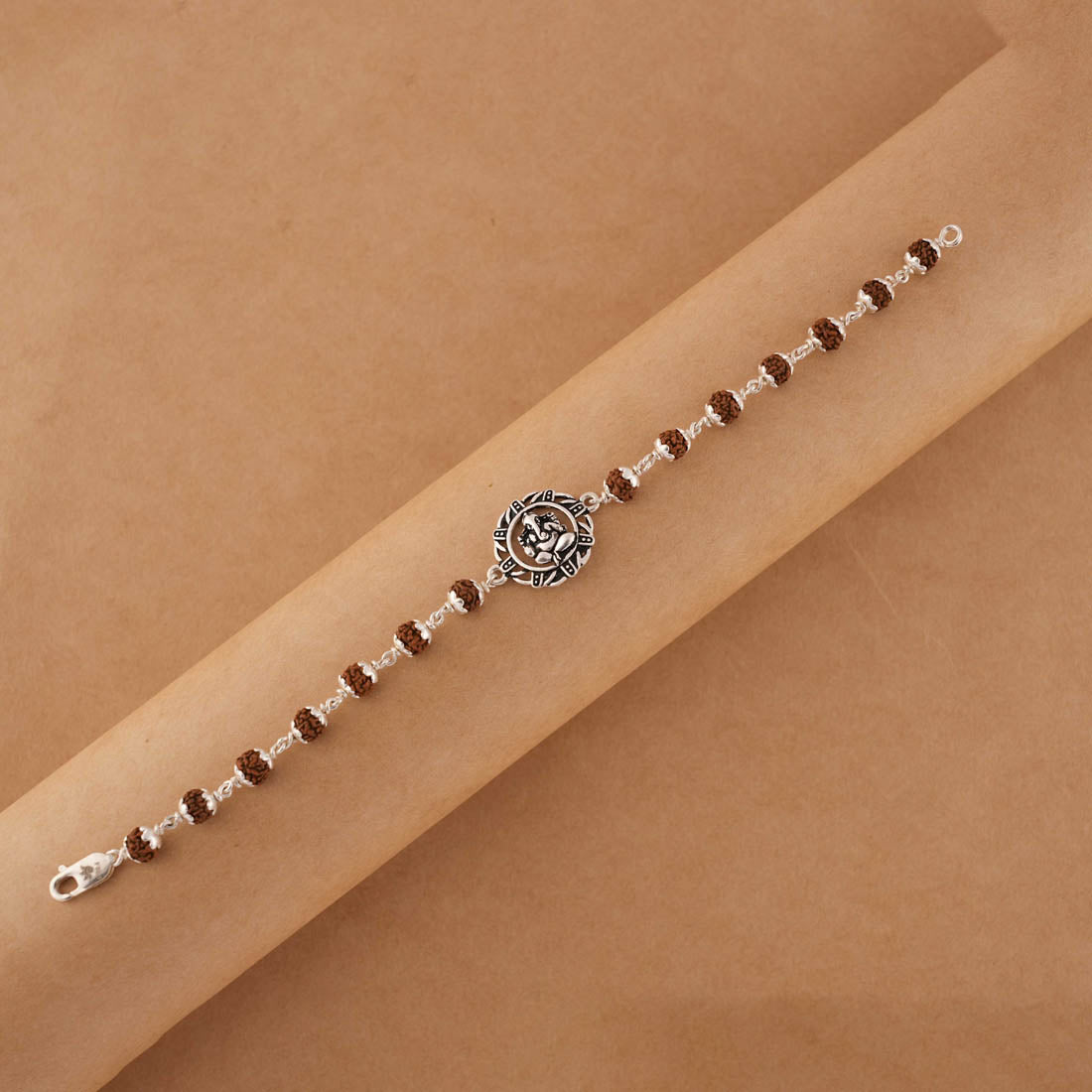 Rudraksha silver bracelet with Ganesh in a designer circular sphere single line
