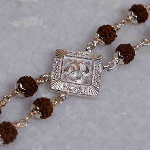 Silver Rakhi with Rudraksha, Om, and Rhombus Double Line Design