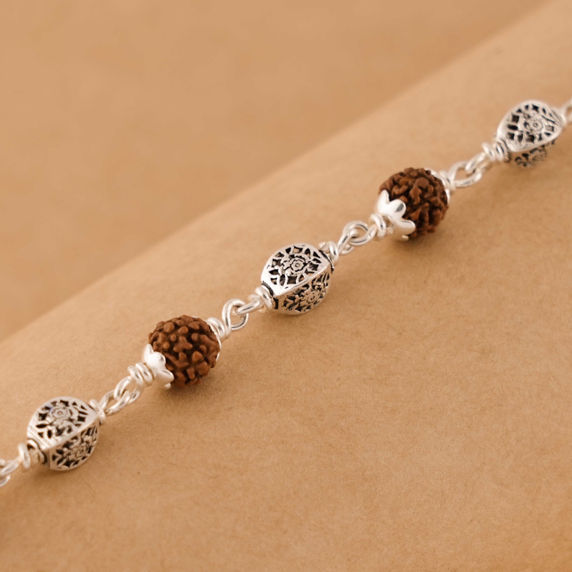 Silver Rakhi with Rudraksha and Hollow Circular Beads