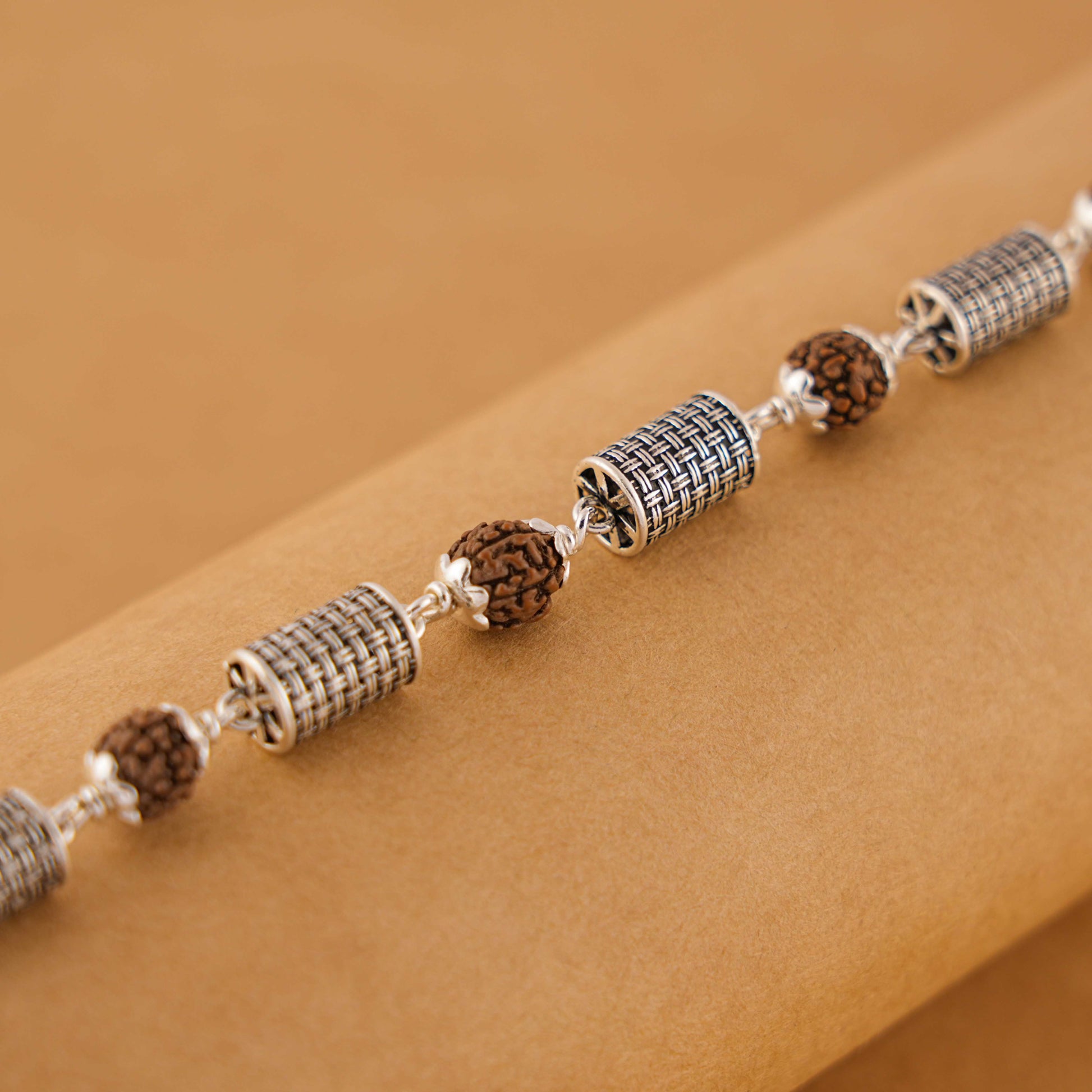 Silver Rakhi with Rudraksha and Hollow Cylindrical Beads