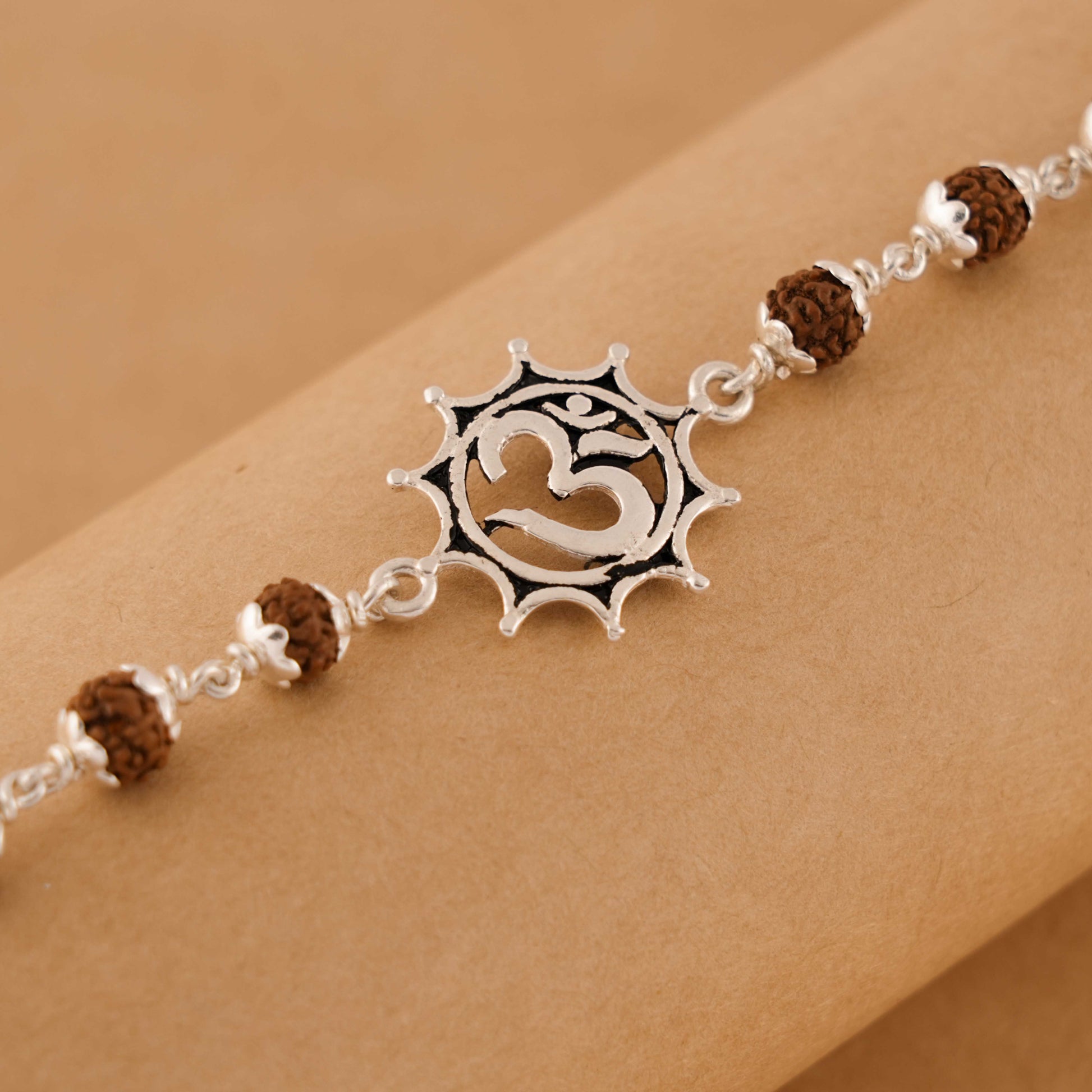 Silver Rakhi with Om in Pointed Circle and Single Line Rudraksha