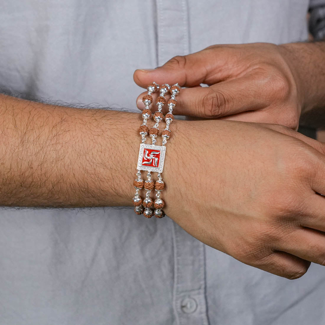 Rudraksha Silver Swastik in Red Triple Line Bracelet