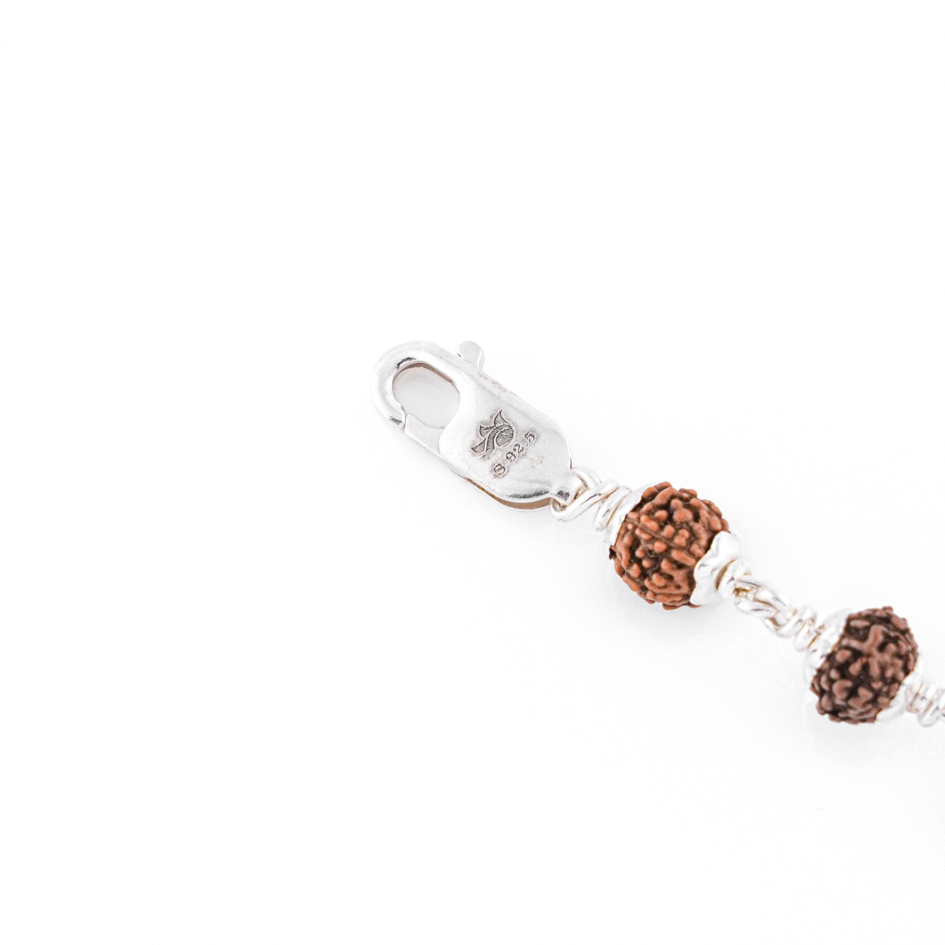 Silver Rakhi with Rudraksha and Three Diamond Cylinders