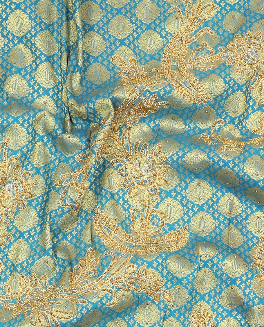 Blue embossed silksaree with stonework, contrast cutwork border & rich stonework pallu & unstitched aari blouse