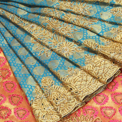 Blue embossed silksaree with stonework, contrast cutwork border & rich stonework pallu & unstitched aari blouse