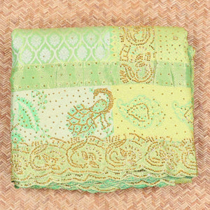 Green silk saree of ogee design with stonework, self curve border of peacock design & grand pallu embedded with stones