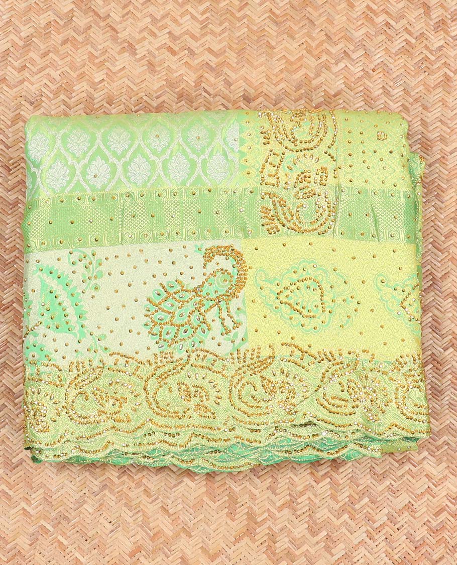 Green silk saree of ogee design with stonework, self curve border of peacock design & grand pallu embedded with stones