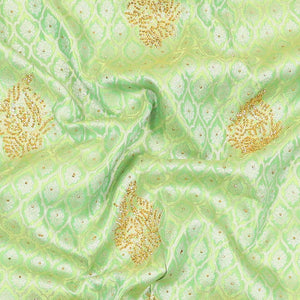 Green silk saree of ogee design with stonework, self curve border of peacock design & grand pallu embedded with stones
