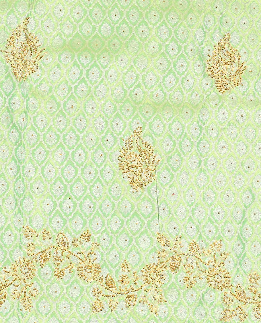 Green silk saree of ogee design with stonework, self curve border of peacock design & grand pallu embedded with stones